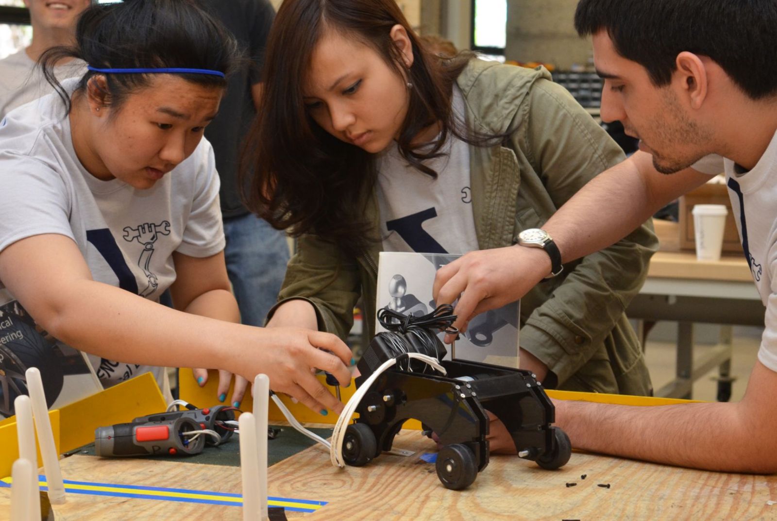 Photo of students working in a robotics laboratory engaged in hands on learning.